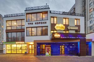 a store front of a building with a sign on it at Three Crowns Hotel in Lviv