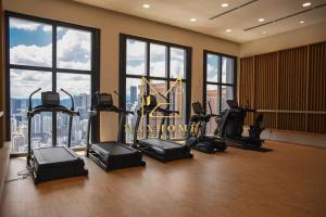 a gym with treadmills and exercise equipment in a building at Maxhome Plus at Lucentia Bukit Bintang City centre KL in Kuala Lumpur