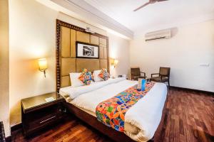 a bedroom with a large bed in a room at FabHotel BMK Grand in New Delhi