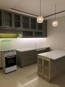 a kitchen with a stove and a counter top at Arana Suite in Legian