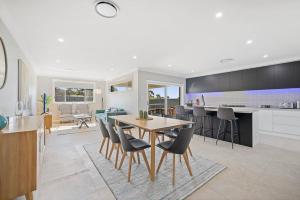 a kitchen and dining room with a table and chairs at 'Devan House' Family Retreat with Games Room in Mudgee