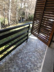 a patio with a bench and a wire on the ground at Apartman Petrovic- 300m od gondole in Brzeće