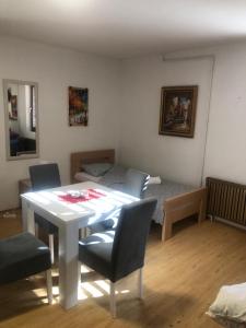 a room with a table and chairs and a bed at Apartman Petrovic- 300m od gondole in Brzeće