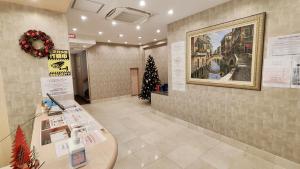 a lobby with a table and a christmas tree at Dotonbori Shinsaibashi Hotel in Osaka
