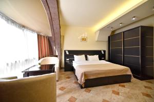 a hotel room with a bed and a couch at Skyline Hotel Yerevan in Yerevan