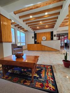 a living room with a wooden table and a couch at Soke Boutique Homestay in Gangtok