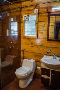 a bathroom with a toilet and a sink at KAYANIV Ayurveda & Wellness Resort in Mandrem