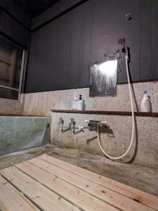 a bath room with a shower and a sink at Baco Myoko Akakura in Myoko +55 photos