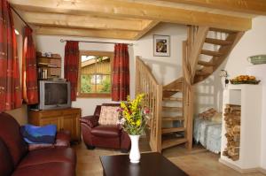 a living room with a couch and a staircase at Ferienhaus Lenzenbauer in Salzburg