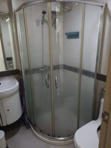 a shower in a bathroom with a toilet at Sobere Unit in Manila