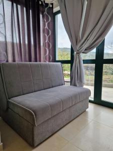 a couch in a room with a window at Lavanda apartman 1 in Cres