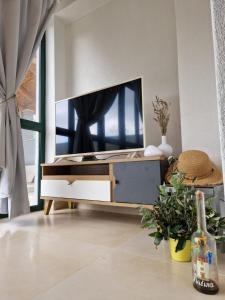 a living room with a tv on a cabinet at Lavanda apartman 1 in Cres
