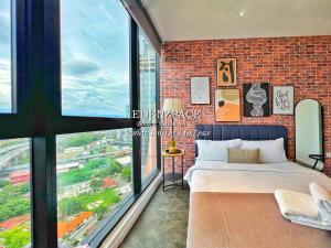 a bedroom with a brick wall and a bed and a window at Scarletz Suites by Edenzpace @ KLCC Area in Kuala Lumpur