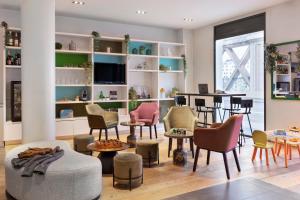 a living room with chairs and a table at Mercure Paris Gare du Nord in Paris