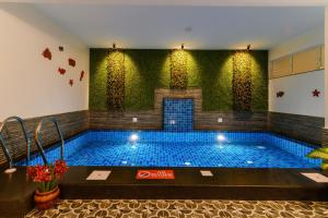 a large swimming pool in the middle of a building at Lotus & Orchid Villas by Ramnath Homes in Sangolda