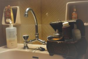 a bathroom counter with a sink with a sink at Georgia's Village House in Kondóstavlos