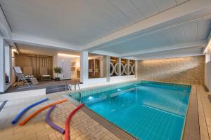 a large swimming pool in a house at Hotel Bichlhof in Reit im Winkl
