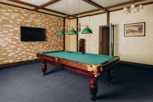 a pool table in a room with a tv at Wonder in Palyanytsya