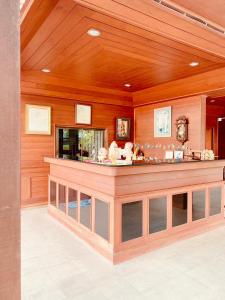 a large room with a counter in a building at Baan Karnjana Hotel Samui in Koh Samui 