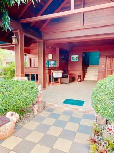 a porch of a house with a piano at Baan Karnjana Hotel Samui in Koh Samui 