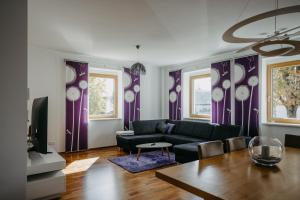 a living room with a couch and a table at Mareli Neusiedler Stadthaus in Neusiedl am See