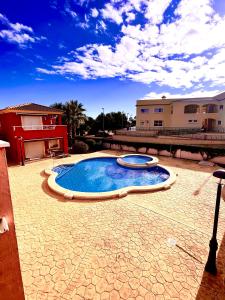 a small swimming pool in a yard with a house at Altaona Comfort & Calidad Villa in Murcia
