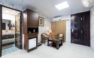 a room with a table and a bathroom with a sink at InnBox Farmstay - Rajpura Punjab in Banūr