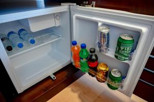 an open refrigerator filled with drinks and soda at Avega Urban - Colombo 07 in Colombo