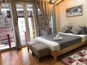 a bedroom with a bed and a large window at Hanoi Secret Garden in Hanoi