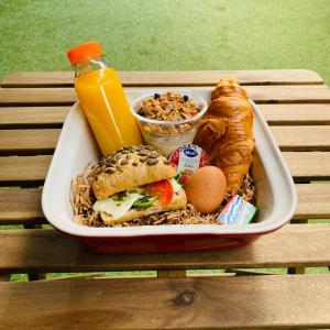 a tray of food with a sandwich and bread and a drink at Outside Inn in Amsterdam