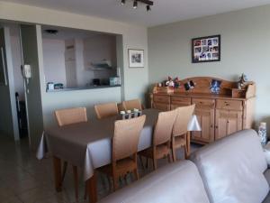 a dining room with a table and some chairs at Appartement zeedijk Heist met garage in Knokke-Heist +5 photos