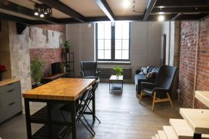 a living room with a table and chairs and a couch at RedCity LOFT 309 in Żyrardów