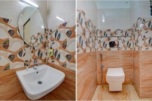 a bathroom with a sink and a toilet and a mirror at FabHotel Greenwood Xpress in Bangalore