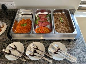 a counter with a tray of food and plates of food at A pristine BB located in the peaceful suburb of Belvedere Harare - 2007 in Harare