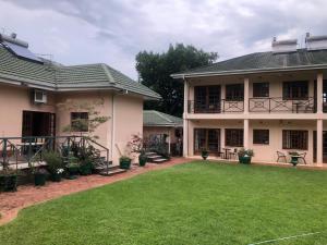 a house with a lawn in front of it at A boutique lodge situated in a serene environment - 2024 in Harare