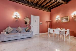 a living room with a couch and a table at APT ROME - Pietra in Rome