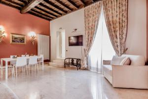 a living room with a white couch and a table at APT ROME - Pietra in Rome