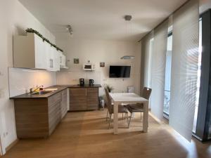 a kitchen with a table and chairs and a dining room at FeWo am Zwinger 2 in Dresden