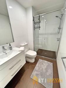 a bathroom with a shower and a toilet and a sink at Bright in Braddon! 1 bd 1bth Apt in Canberra