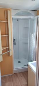 a glass shower in a bathroom with at REGENCY HOLIDAY Tour Opérateur dans Camping 5 étoiles Frejus, Cote d'Azur in Fréjus