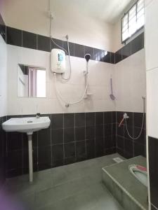 a bathroom with a sink and a shower at Seaview Promenade Homestay Dungun in Dungun