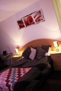 a bedroom with a bed with two lamps on tables at Perfectly Located Modern Apartment - Canberra CBD in Canberra