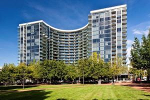a tall building with a park in front of it at Perfectly Located Modern Apartment - Canberra CBD in Canberra