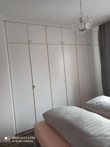 a bedroom with a bed and a chandelier at Nordlicht in Schortens