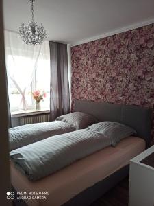 a bedroom with two beds and a window at Nordlicht in Schortens