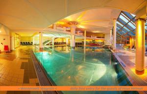 a large indoor swimming pool in a building at Haus Heimat Wagrain in Wagrain