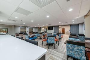 a dining room with tables and chairs and a cafeteria at Comfort Inn Chicago Schaumburg - O'Hare Airport in Schaumburg