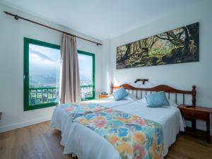 a bedroom with two beds and large windows at Hotel Ida Inés in Frontera