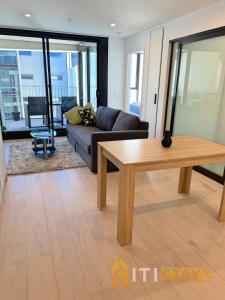 a living room with a couch and a table at Splendid 2bd 1bth 1csp Apt - Superb CBD Location in Canberra