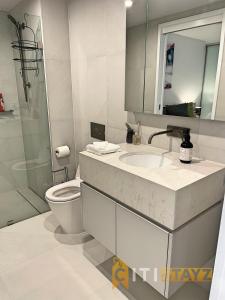 a bathroom with a sink and a toilet and a mirror at Splendid 2bd 1bth 1csp Apt - Superb CBD Location in Canberra